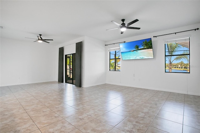 spare room featuring ceiling fan and light tile patterned floors