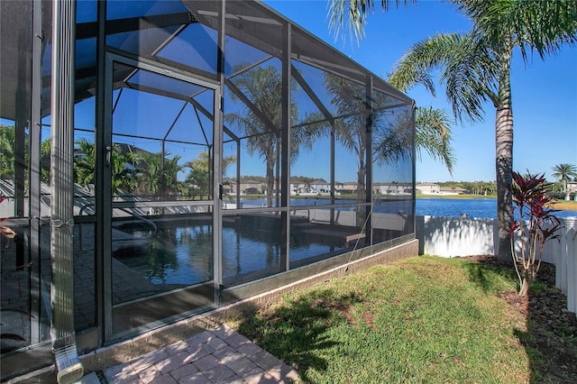 view of swimming pool featuring a lanai and a water view