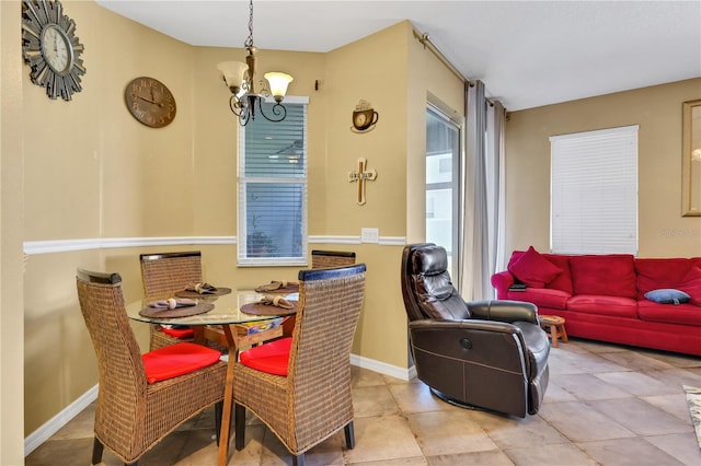 tiled dining space with a notable chandelier