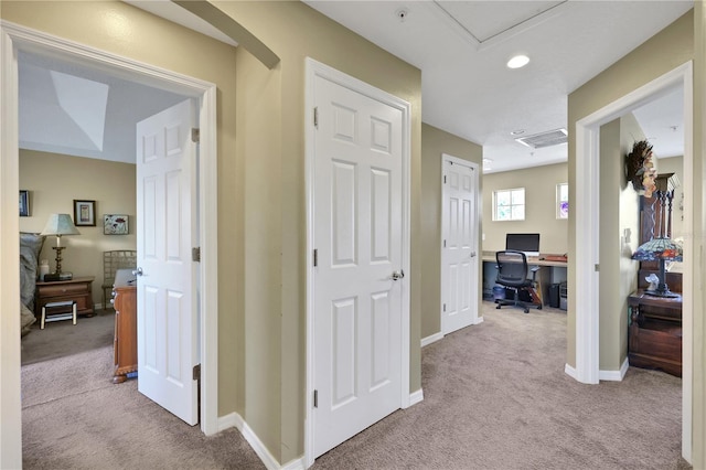 corridor with light colored carpet