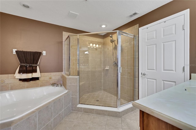 bathroom with tile patterned flooring, a textured ceiling, vanity, and separate shower and tub