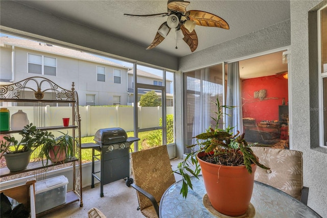 sunroom / solarium featuring ceiling fan