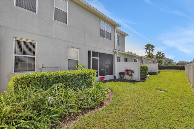 rear view of property featuring a yard