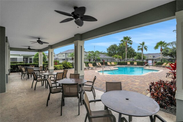 view of swimming pool featuring a patio and ceiling fan