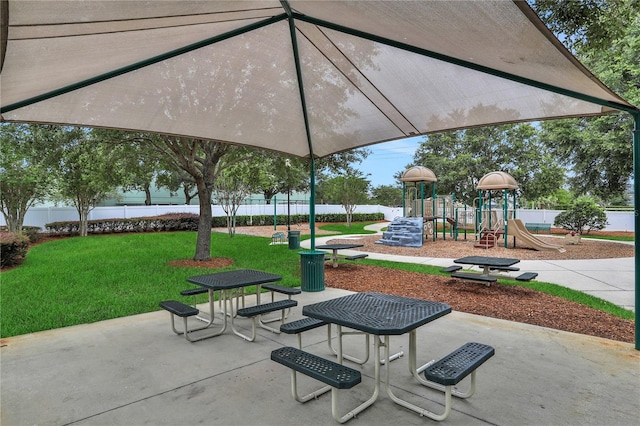 view of home's community with a playground and a lawn