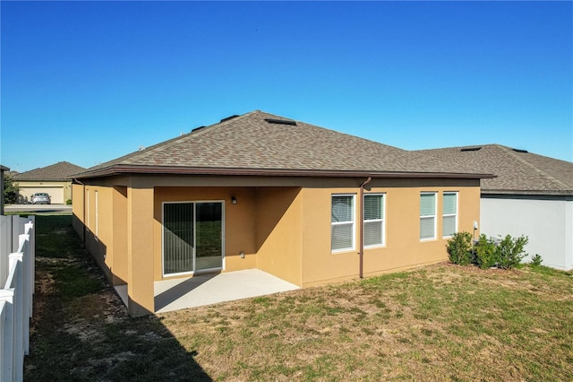 rear view of house with a yard and a patio