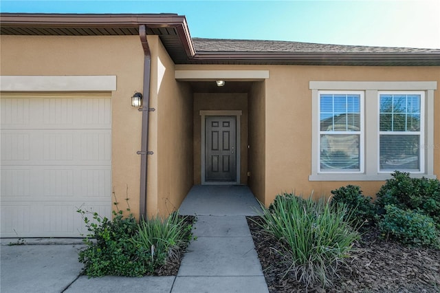 view of exterior entry with a garage