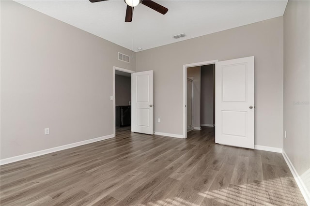 unfurnished bedroom featuring ceiling fan and dark wood-type flooring