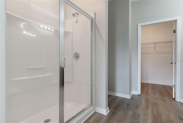 bathroom with wood-type flooring and walk in shower