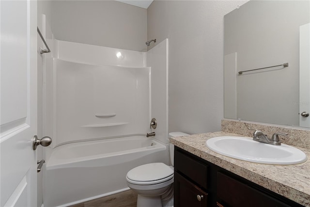 full bathroom with hardwood / wood-style flooring, vanity, toilet, and shower / washtub combination