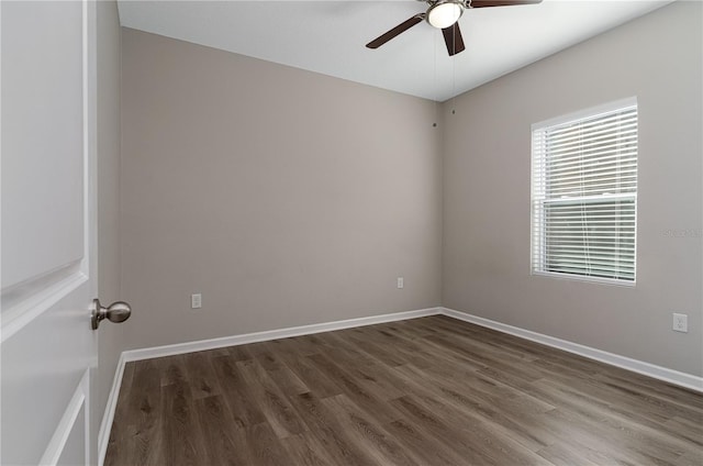 spare room featuring dark hardwood / wood-style flooring and ceiling fan