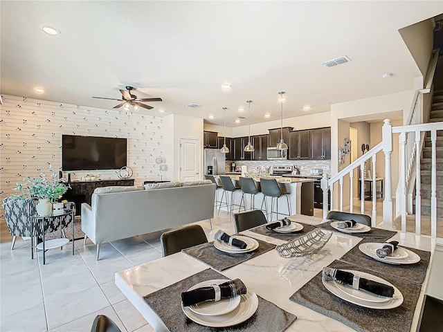 tiled dining area with ceiling fan