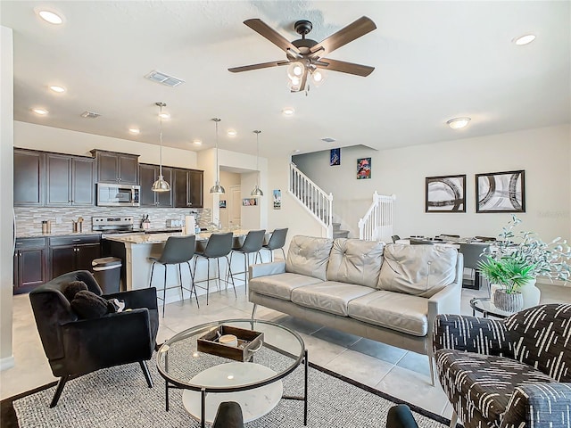 living room featuring ceiling fan and light tile patterned floors