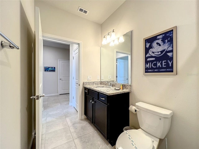 bathroom featuring tile patterned flooring, vanity, and toilet