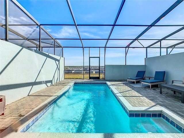 view of swimming pool with a lanai and a patio