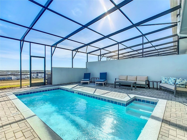 view of swimming pool featuring a lanai, a patio area, and an outdoor hangout area