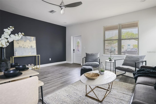 living room featuring hardwood / wood-style floors and ceiling fan