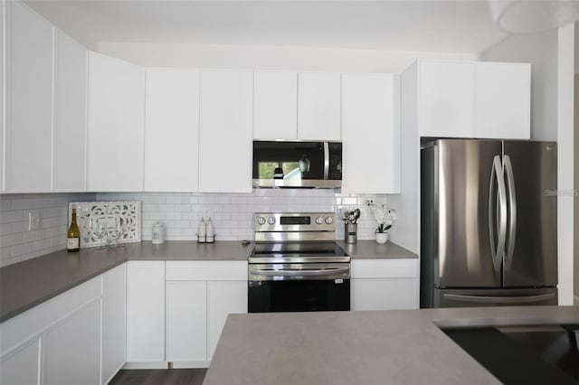 kitchen featuring tasteful backsplash, white cabinets, and appliances with stainless steel finishes