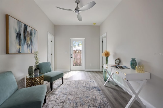 sitting room featuring ceiling fan and light hardwood / wood-style flooring