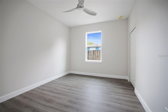 empty room with ceiling fan and dark wood-type flooring