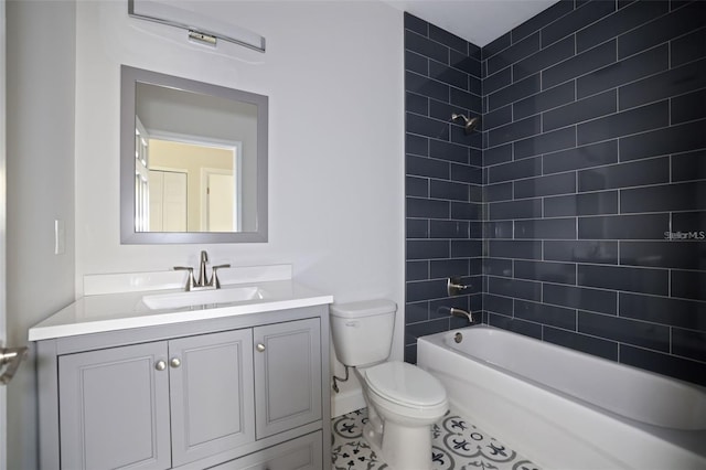 full bathroom with toilet, tile patterned flooring, vanity, and tiled shower / bath