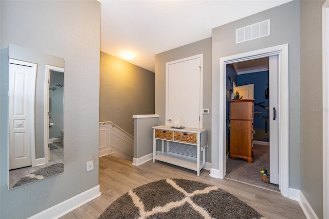 interior space featuring light hardwood / wood-style flooring and ornamental molding