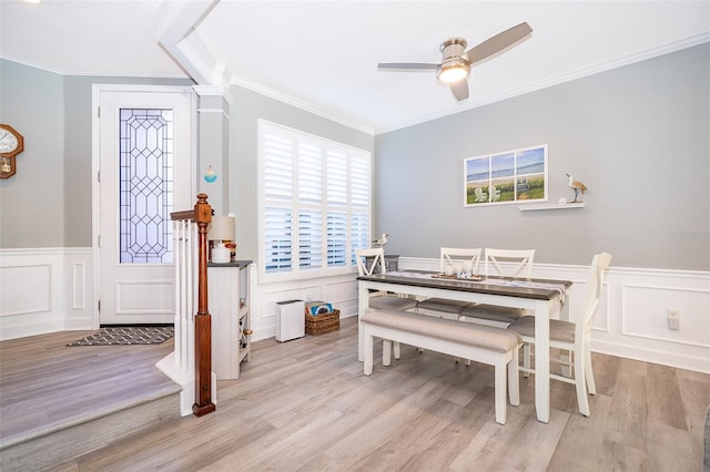 dining area with ceiling fan, light hardwood / wood-style floors, and ornamental molding