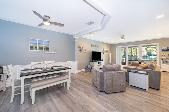 living room with ceiling fan, ornamental molding, and light wood-type flooring