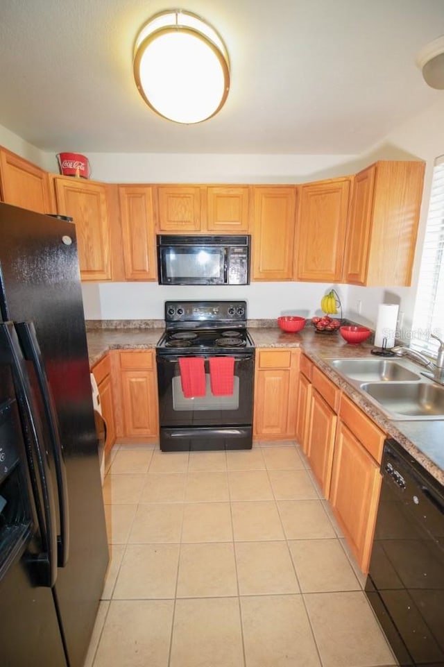 kitchen with light tile patterned flooring, sink, and black appliances