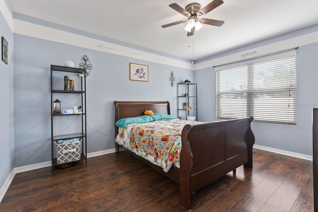 bedroom featuring ceiling fan and dark hardwood / wood-style floors