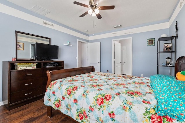 bedroom with dark hardwood / wood-style flooring and ceiling fan