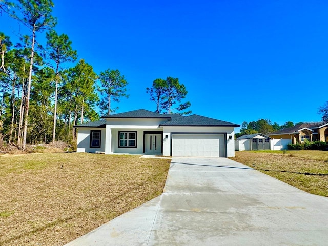 view of front of property with a garage and a front lawn