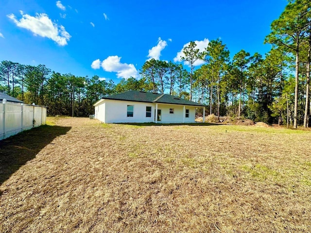 rear view of house with a lawn