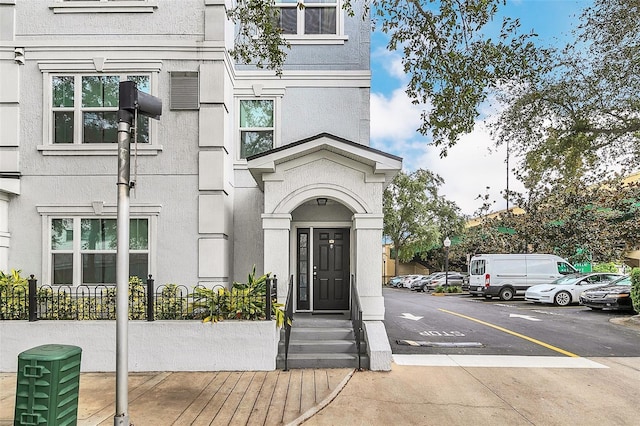 204 E S St Unit 1055, Orlando, FL 32801 - view of exterior entry with uncovered parking and stucco siding