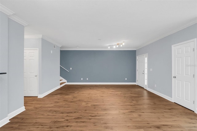 spare room with ornamental molding and hardwood / wood-style flooring