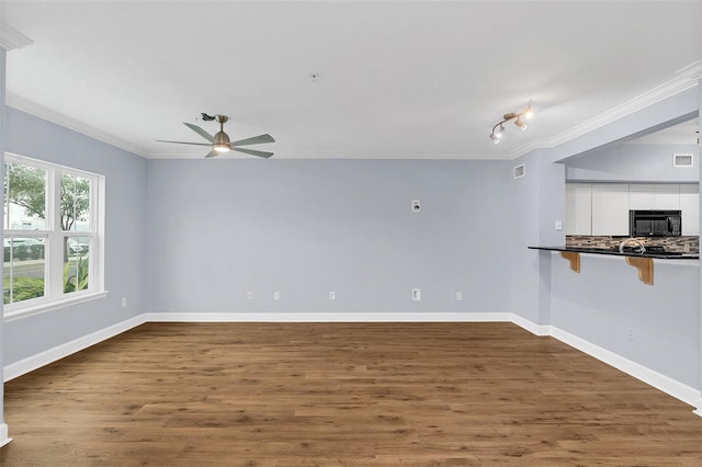 spare room featuring ceiling fan, dark hardwood / wood-style flooring, and ornamental molding