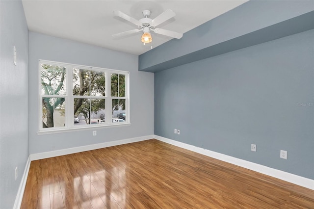 empty room featuring ceiling fan and hardwood / wood-style floors