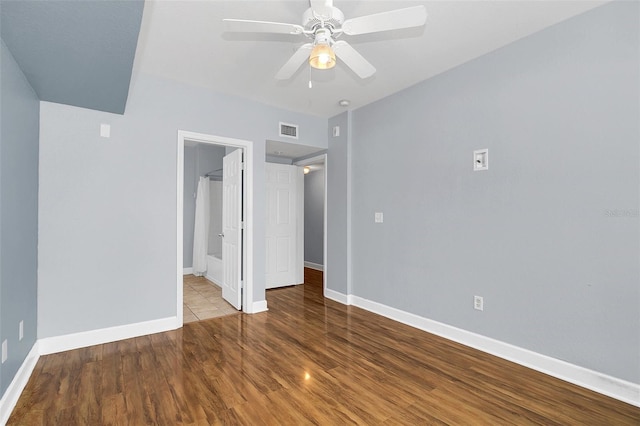 unfurnished bedroom featuring light hardwood / wood-style floors, ceiling fan, and ensuite bathroom