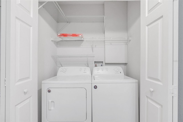 clothes washing area with separate washer and dryer