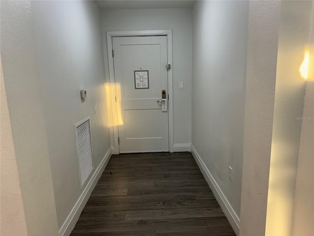 doorway featuring dark wood-type flooring