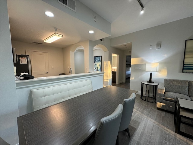 dining area with dark hardwood / wood-style floors