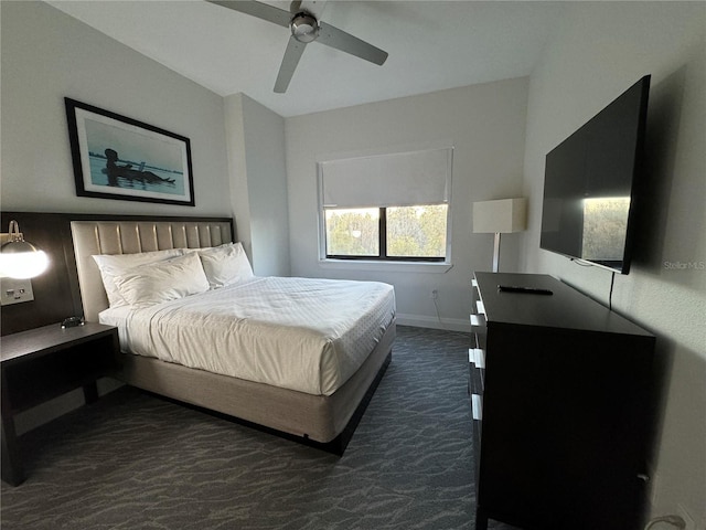 bedroom with ceiling fan and dark colored carpet