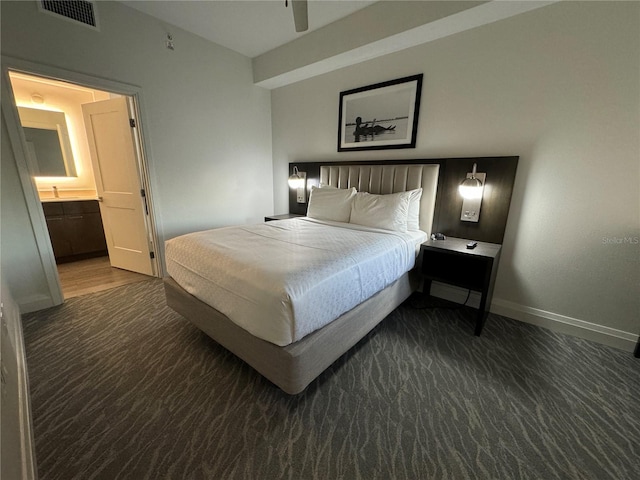 carpeted bedroom featuring ceiling fan and ensuite bath