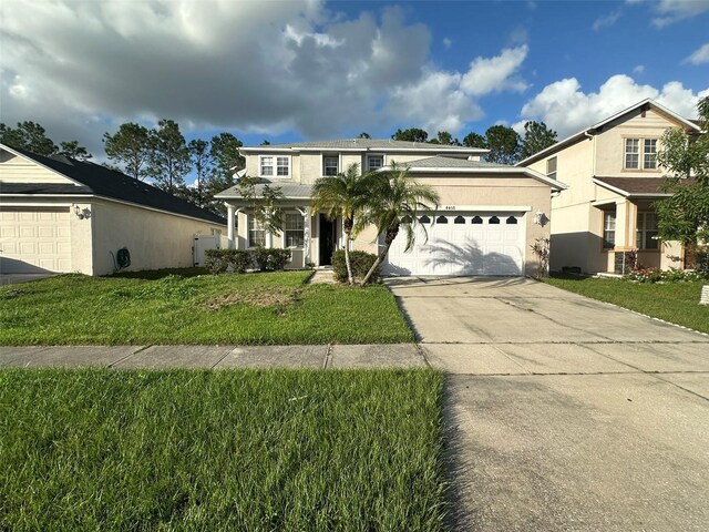 view of front of property with a garage and a front lawn