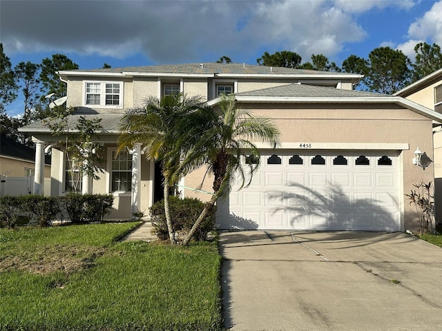 view of front of home featuring a front yard and a garage