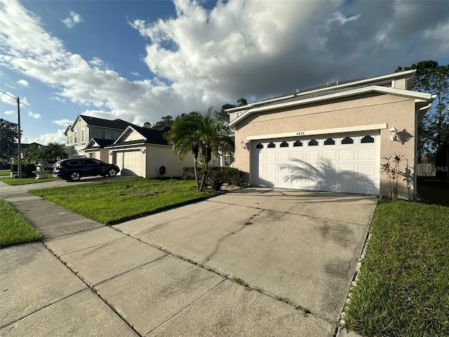 ranch-style house featuring a front yard and a garage