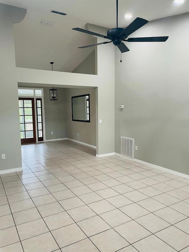 unfurnished room with light tile patterned floors, high vaulted ceiling, and ceiling fan