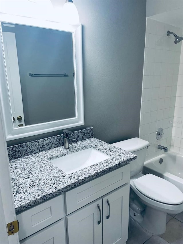 full bathroom with tile patterned flooring, vanity, toilet, and tiled shower / bath combo