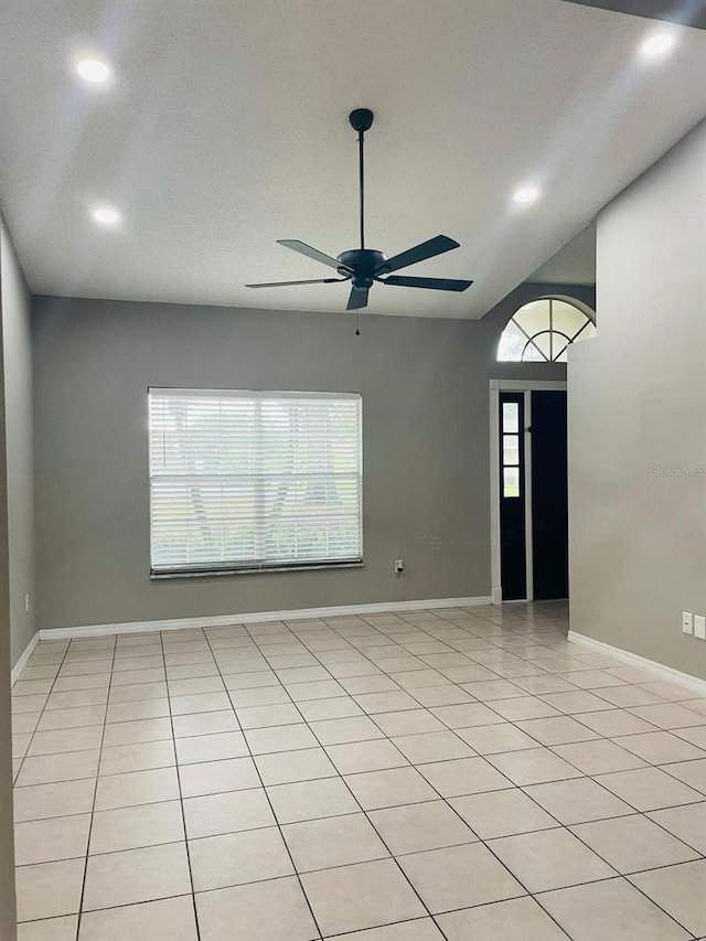 entrance foyer featuring light tile patterned floors, ceiling fan, and lofted ceiling