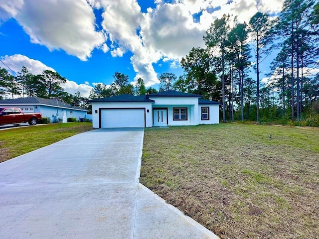 view of front of home featuring a garage and a front lawn